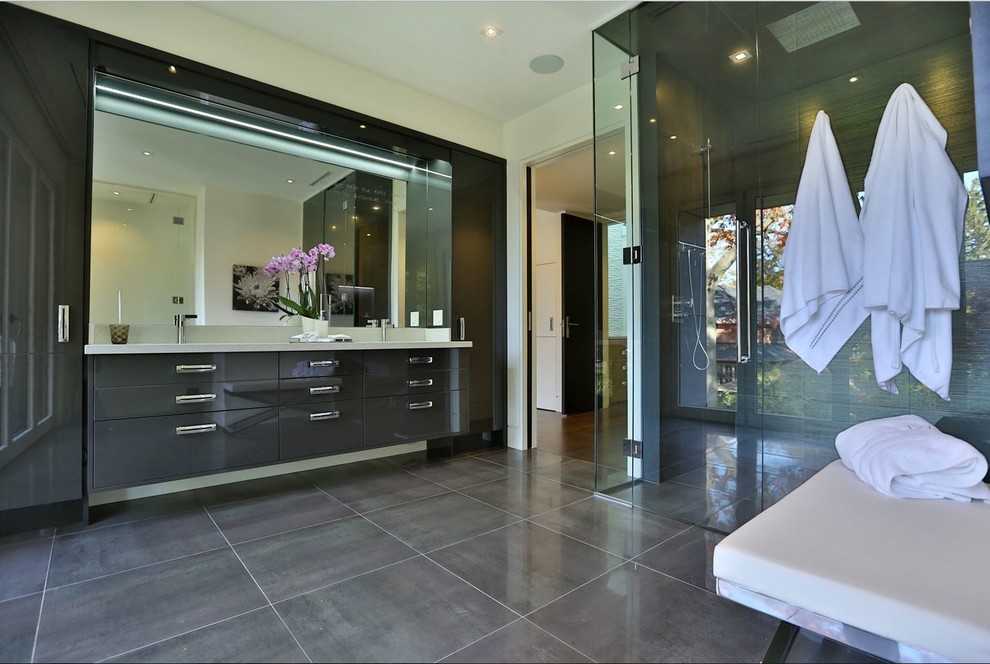 Photo of a large contemporary master bathroom in Toronto with an undermount sink, flat-panel cabinets, grey cabinets, engineered quartz benchtops, a curbless shower, gray tile, porcelain tile, white walls and porcelain floors.