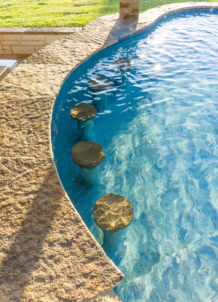 Large mountain style backyard stone and custom-shaped pool fountain photo in Austin