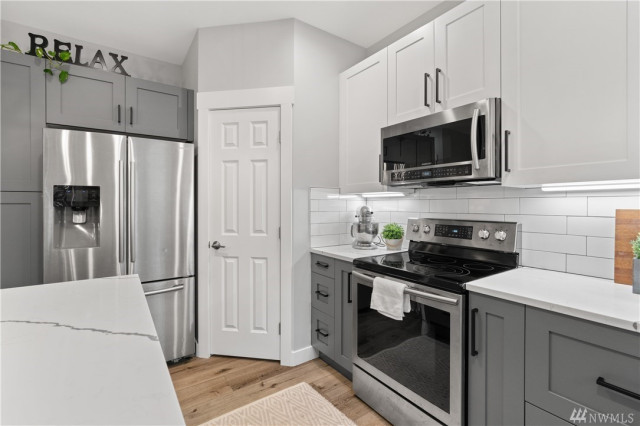 Transitional Home with Bold Blue Exterior & Modern Two-Tone Kitchen fusion-kitchen