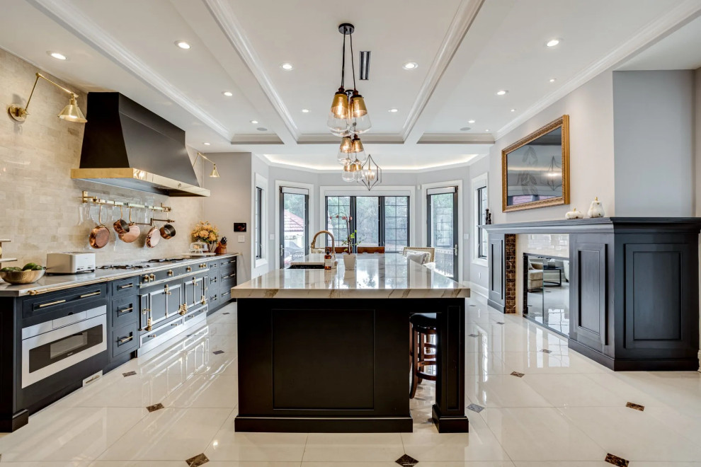Transitional beige floor kitchen photo in Baltimore with black cabinets, beige backsplash, an island and beige countertops