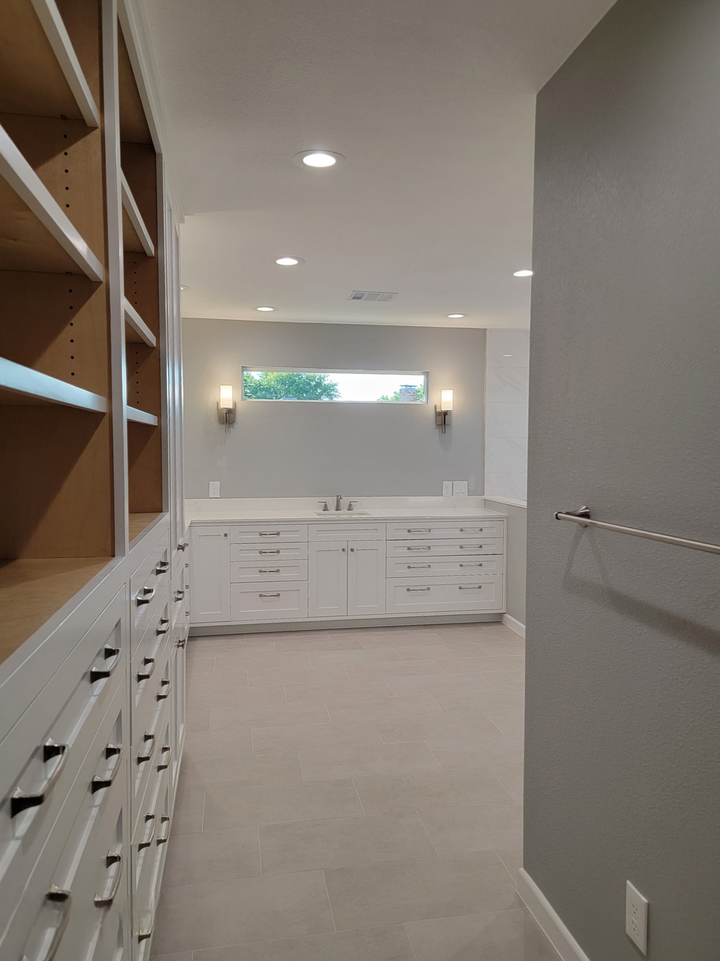 Two separate bathrooms converted into a master bathroom with a big open closet
