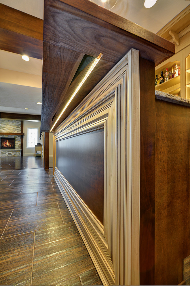 Inspiration for a mid-sized rustic walk-out home design remodel with beige walls, a standard fireplace and a stone fireplace