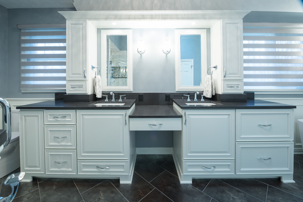 Mid-sized eclectic master wet room bathroom in Indianapolis with raised-panel cabinets, white cabinets, a two-piece toilet, black and white tile, ceramic tile, blue walls, ceramic floors, an undermount sink and quartzite benchtops.
