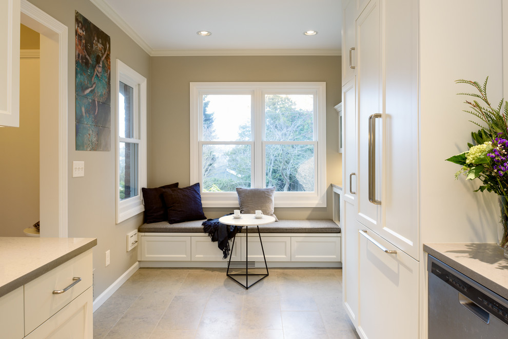 Small transitional u-shaped limestone floor and gray floor enclosed kitchen photo in Seattle with an undermount sink, recessed-panel cabinets, white cabinets, quartz countertops, gray backsplash, ceramic backsplash, stainless steel appliances, no island and gray countertops