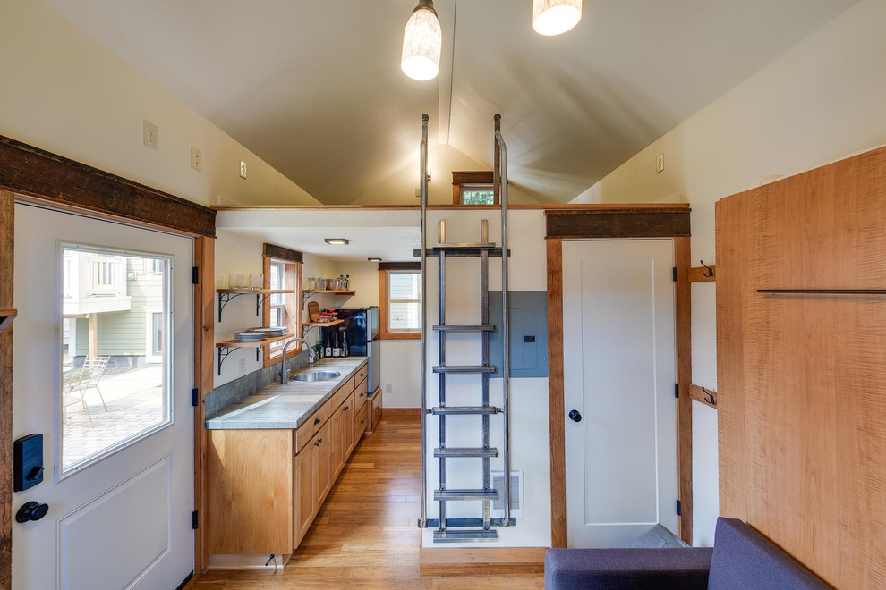 Small traditional galley eat-in kitchen in Portland with a drop-in sink, recessed-panel cabinets, medium wood cabinets, limestone benchtops, grey splashback, slate splashback, stainless steel appliances, medium hardwood floors, brown floor and grey benchtop.