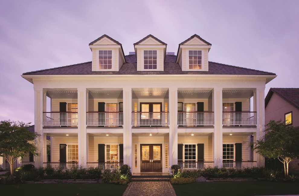 Inspiration for a traditional three-storey white exterior in Other with vinyl siding.