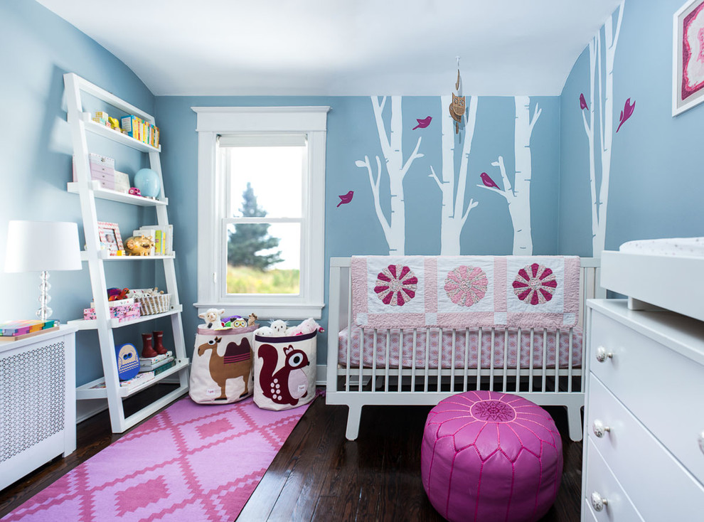 Mid-sized transitional gender-neutral nursery in New York with blue walls, dark hardwood floors and brown floor.