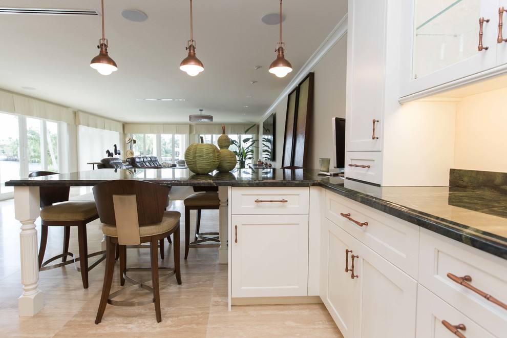 Example of a large transitional u-shaped light wood floor open concept kitchen design in Miami with a farmhouse sink, shaker cabinets, stainless steel appliances, an island, white cabinets, granite countertops, metallic backsplash and mosaic tile backsplash