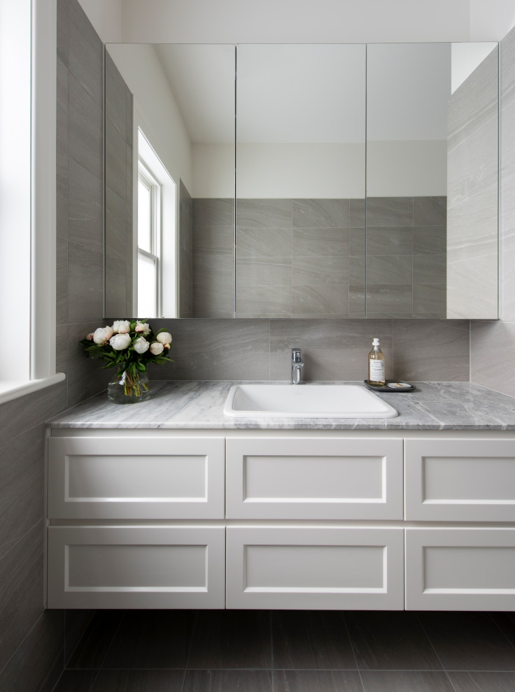 Large contemporary kitchen in Melbourne with raised-panel cabinets, white cabinets, porcelain floors and beige floor.