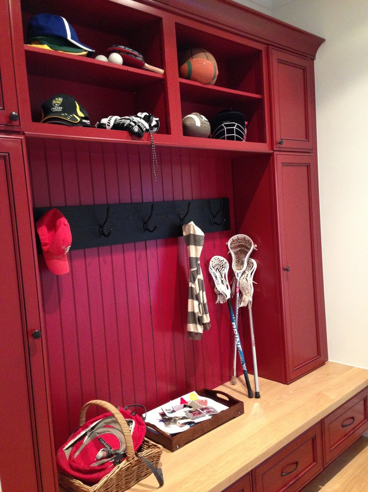 Design ideas for a large transitional mudroom in Melbourne with red walls and light hardwood floors.