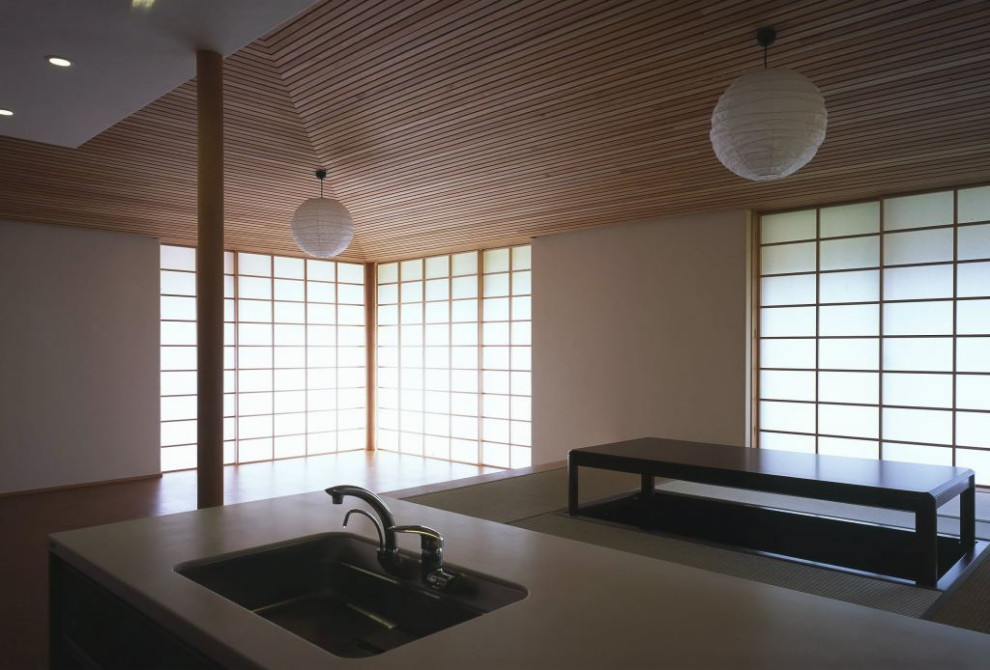 This is an example of a mid-sized traditional kitchen/dining combo in Other with white walls, tatami floors, no fireplace, beige floor and timber.