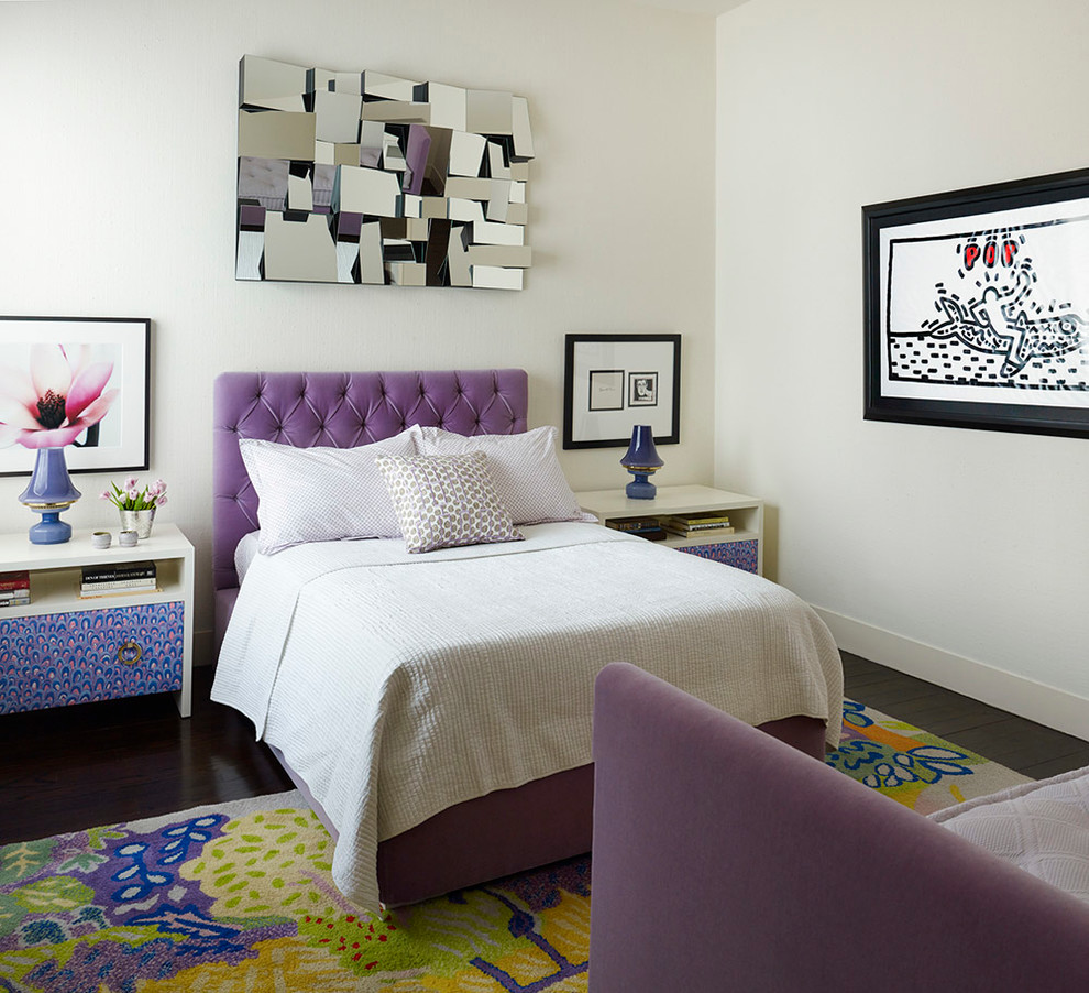 This is an example of a contemporary bedroom in New York with white walls and dark hardwood floors.
