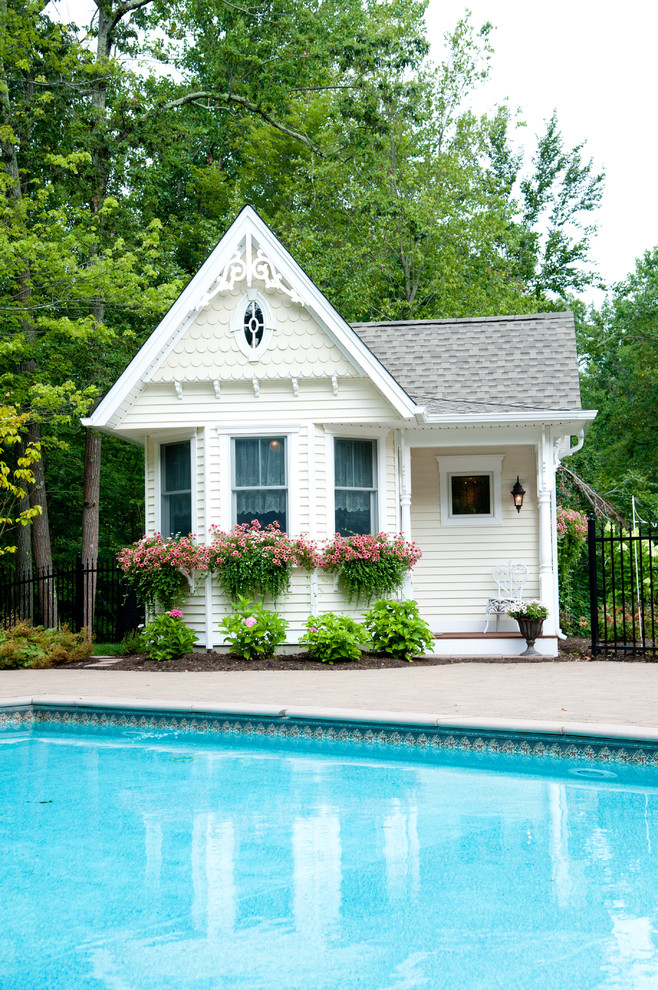 Mid-sized traditional backyard rectangular pool in Bridgeport with a pool house.