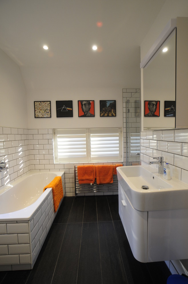 Photo of a contemporary bathroom in Oxfordshire with an integrated sink, white cabinets, white tile, subway tile and a drop-in tub.