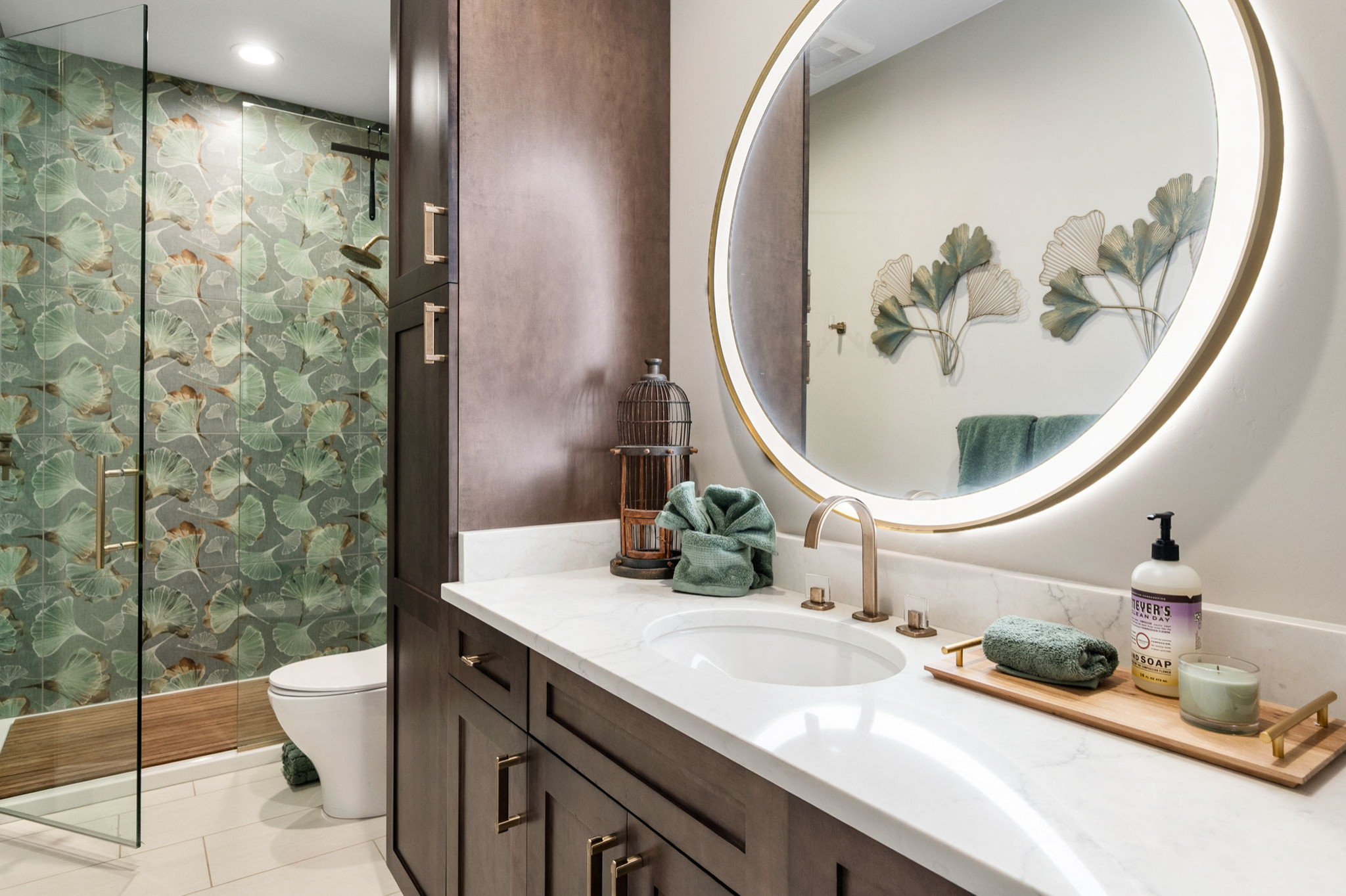 Step into this spa like bathroom with an array of organic textures. From champagne gold finishes to teak wood shower floors and leather cabinet hardware.