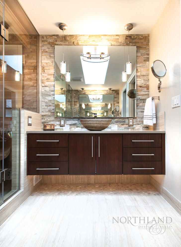Design ideas for a mid-sized contemporary master bathroom in Portland with a vessel sink, flat-panel cabinets, dark wood cabinets, engineered quartz benchtops, beige tile, porcelain tile, a two-piece toilet, grey walls and porcelain floors.