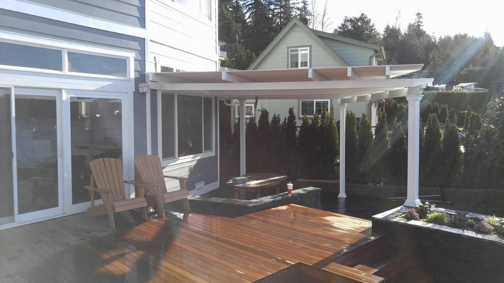 Mid-sized transitional backyard patio photo in Phoenix with decking and a pergola