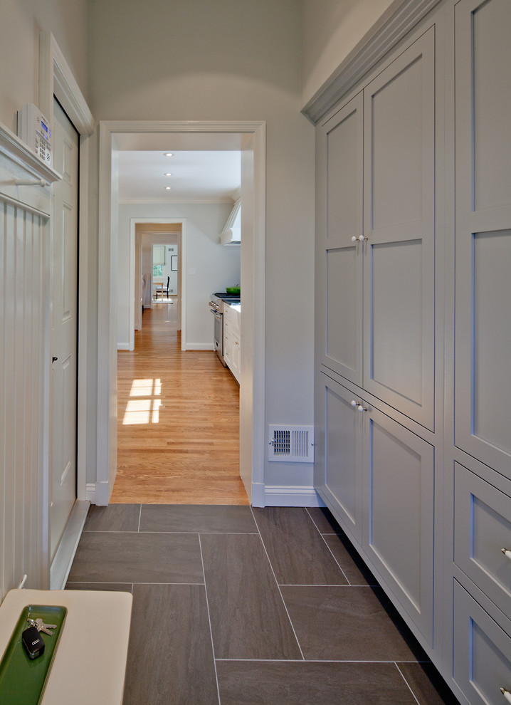 Design ideas for a small traditional mudroom in DC Metro with grey walls, porcelain floors and a single front door.