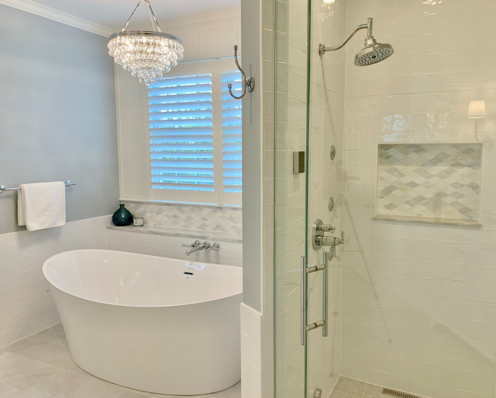 Inspiration for a transitional master bathroom in Other with shaker cabinets, white cabinets, a freestanding tub, a double shower, white tile, porcelain tile, blue walls, porcelain floors, an undermount sink, marble benchtops, grey floor, a hinged shower door, a niche, a double vanity, a built-in vanity and panelled walls.