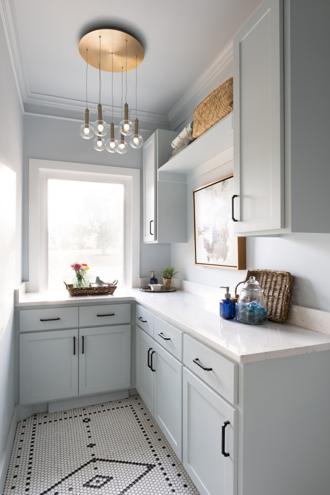 Inspiration for a mid-sized l-shaped dedicated laundry room in Kansas City with recessed-panel cabinets, blue cabinets, quartz benchtops, white splashback, engineered quartz splashback, blue walls, ceramic floors, a side-by-side washer and dryer, multi-coloured floor and white benchtop.