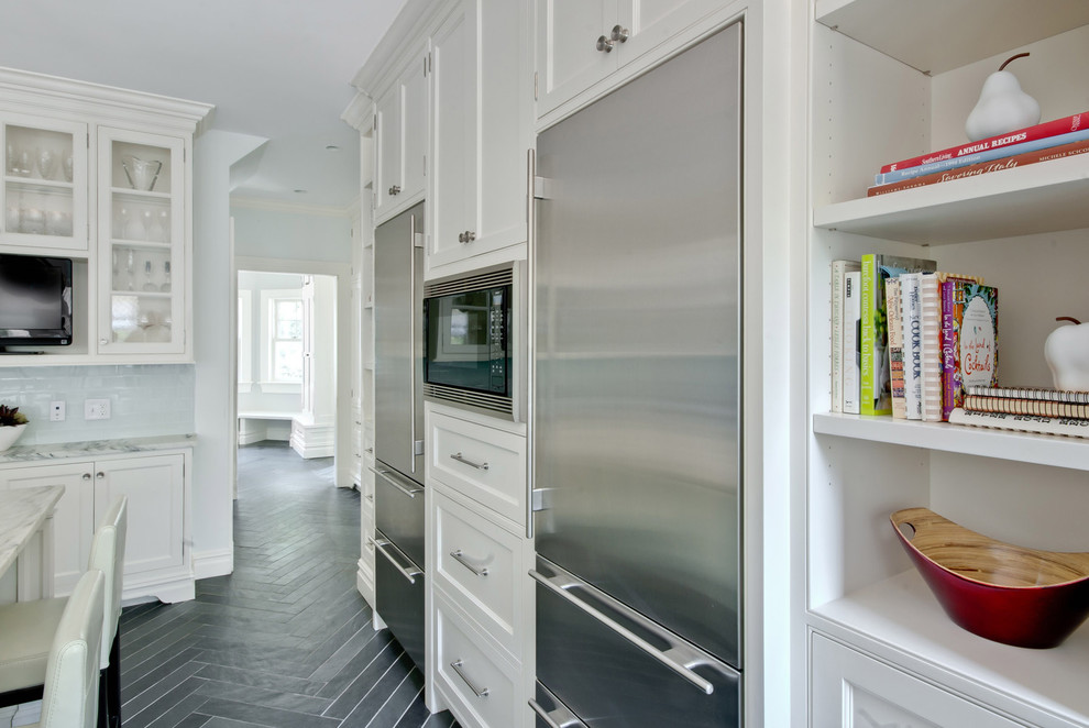 This is an example of a traditional kitchen in New York with beaded inset cabinets, stainless steel appliances and white cabinets.
