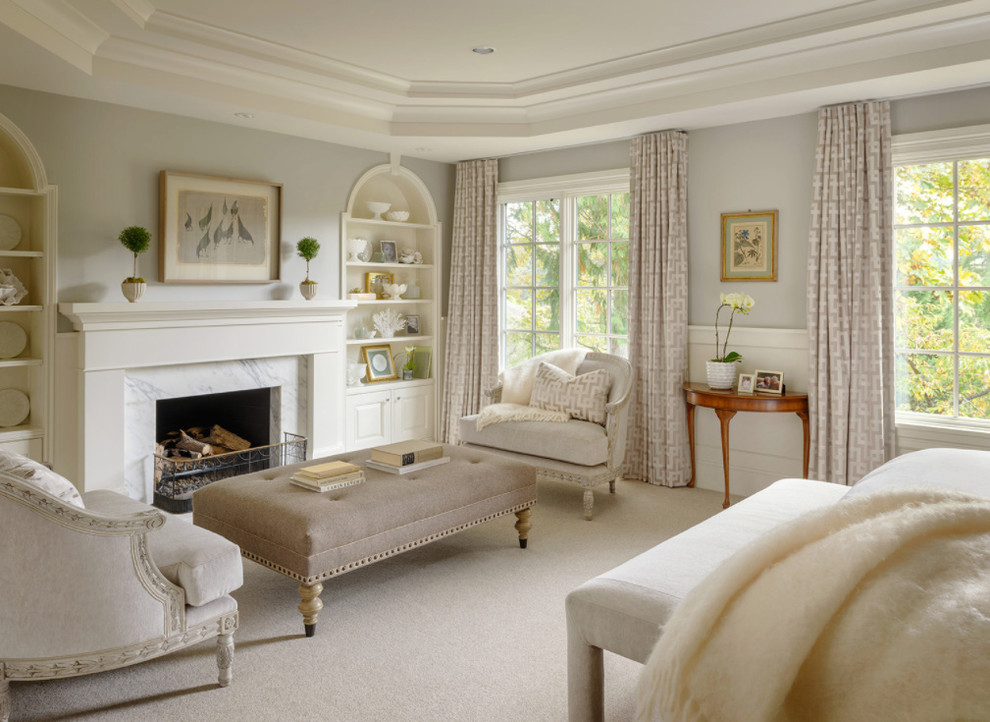 This is an example of a traditional master bedroom in Seattle with grey walls, carpet, a standard fireplace, a stone fireplace surround and beige floor.