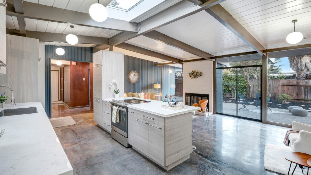 Inspiration for a midcentury kitchen in Austin with flat-panel cabinets, light wood cabinets, quartzite benchtops, with island, exposed beam, concrete floors, grey floor and white benchtop.