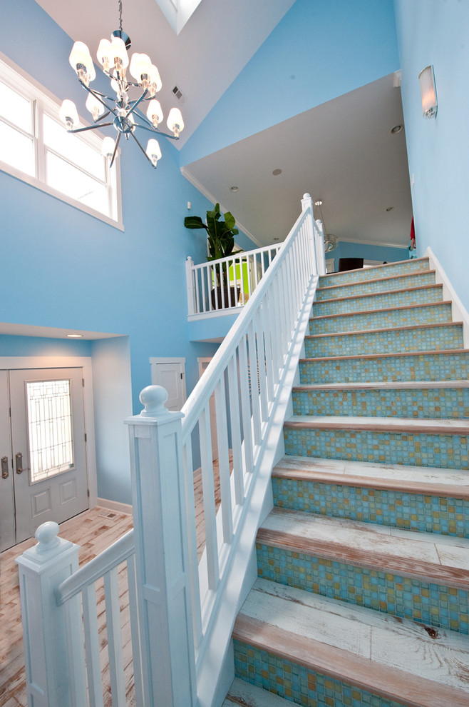 Design ideas for a mid-sized beach style wood straight staircase in DC Metro with wood risers.