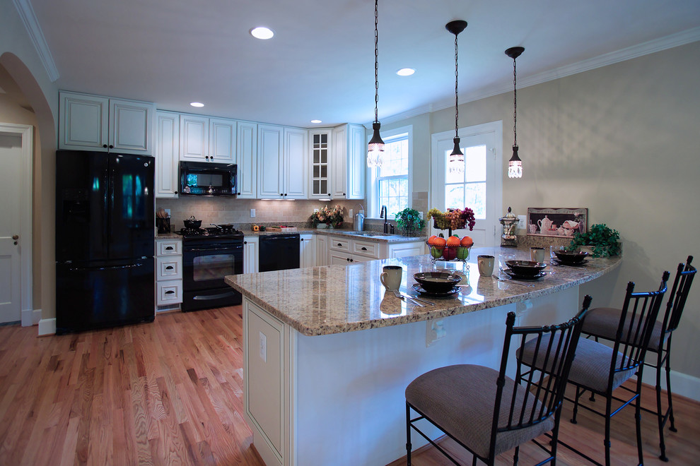 Traditional kitchen in DC Metro with black appliances.