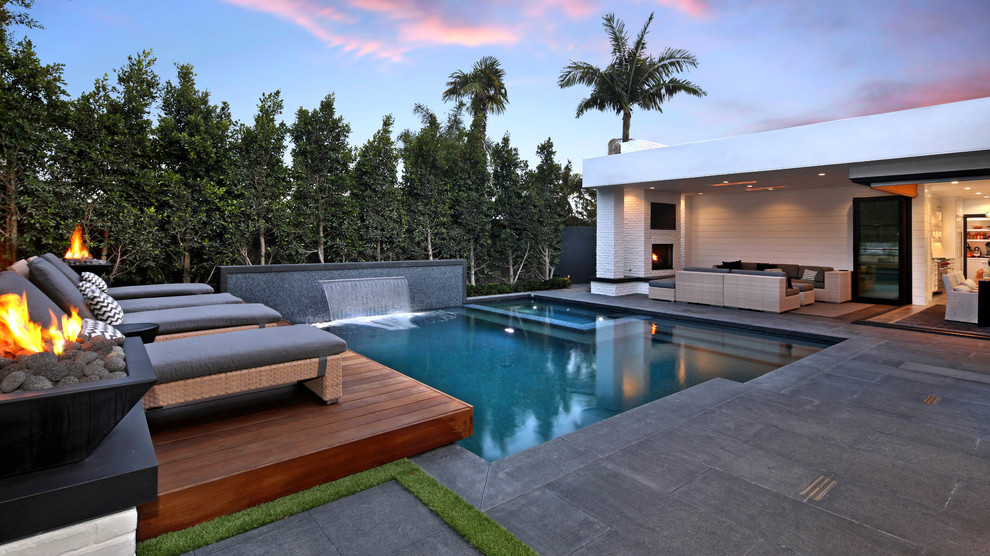 Contemporary pool in Los Angeles with a hot tub and tile.