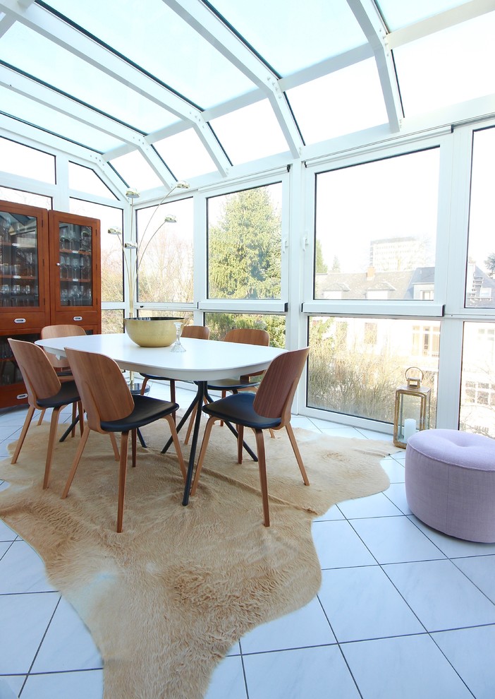 Photo of a transitional sunroom in Frankfurt with no fireplace, a glass ceiling and white floor.