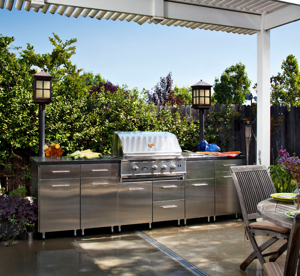 Inspiration for a contemporary backyard patio in Sacramento with an outdoor kitchen, concrete slab and a pergola.