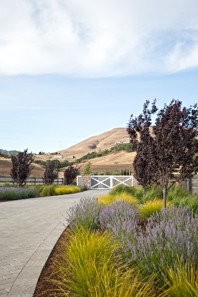 Inspiration for a country driveway in San Luis Obispo with concrete pavers.