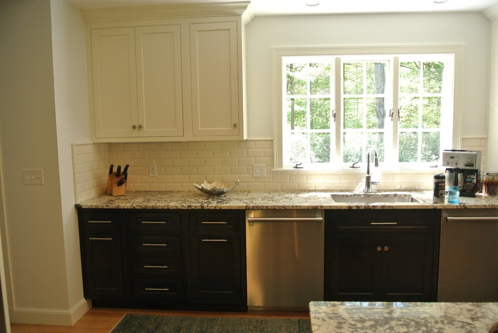 Example of a transitional light wood floor eat-in kitchen design in Boston with an undermount sink, shaker cabinets, granite countertops, white backsplash, subway tile backsplash, stainless steel appliances and an island