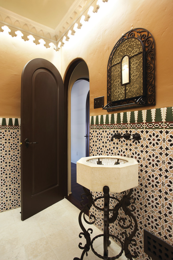 Design ideas for a mediterranean powder room in Orange County with an undermount sink, multi-coloured tile and beige walls.