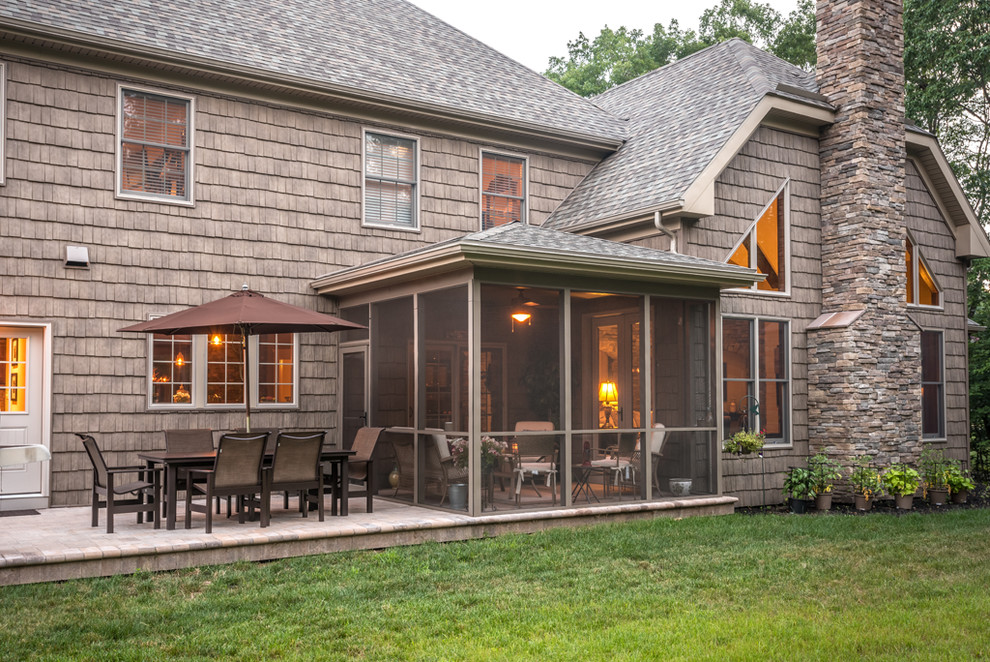 Inspiration for a mid-sized country backyard screened-in verandah in Other with concrete pavers and a roof extension.