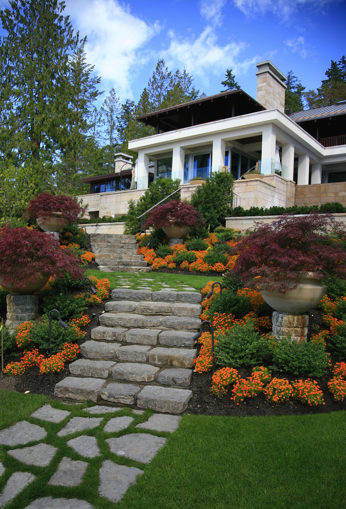 Asian sloped garden in Vancouver with natural stone pavers and a container garden for fall.