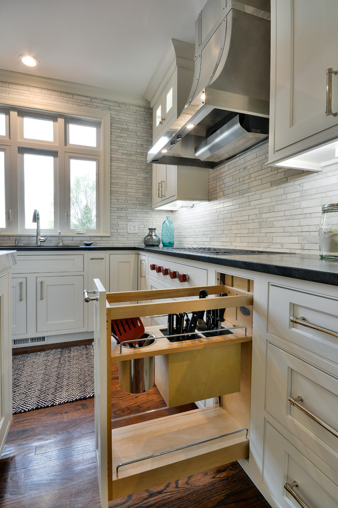Inspiration for a large transitional u-shaped dark wood floor and brown floor eat-in kitchen remodel in Chicago with an undermount sink, recessed-panel cabinets, white cabinets, soapstone countertops, gray backsplash, marble backsplash, stainless steel appliances and an island