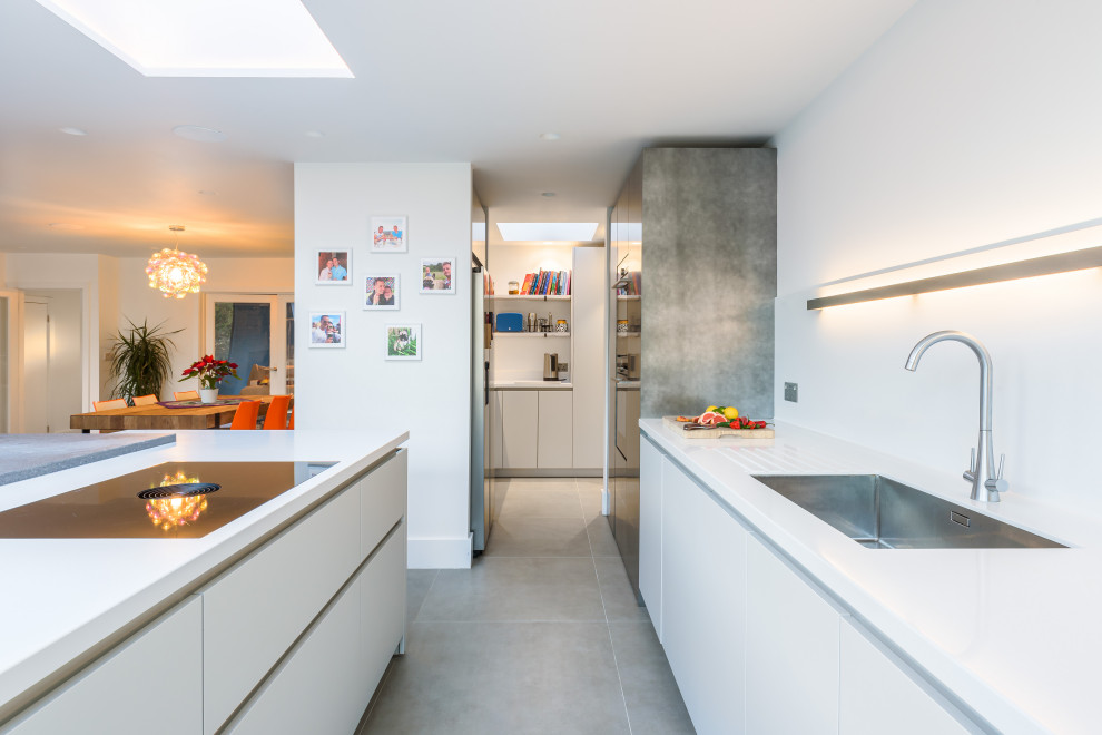 Medium sized contemporary single-wall open plan kitchen in Sussex with an island.