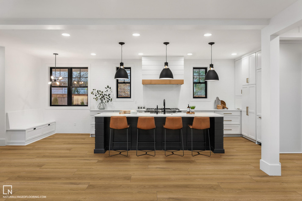 This is an example of a large open plan kitchen in Other with recessed-panel cabinets, white cabinets, vinyl floors, with island and orange floor.
