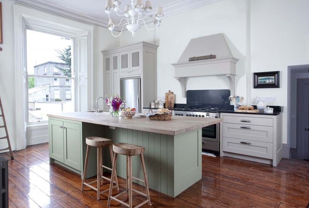 Traditional kitchen in Dublin with shaker cabinets, green cabinets, dark hardwood floors and with island.