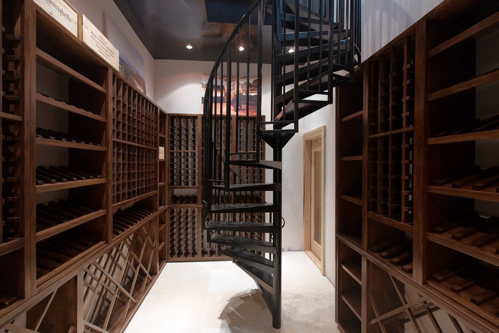 Inspiration for a large timeless marble floor wine cellar remodel in New York with storage racks