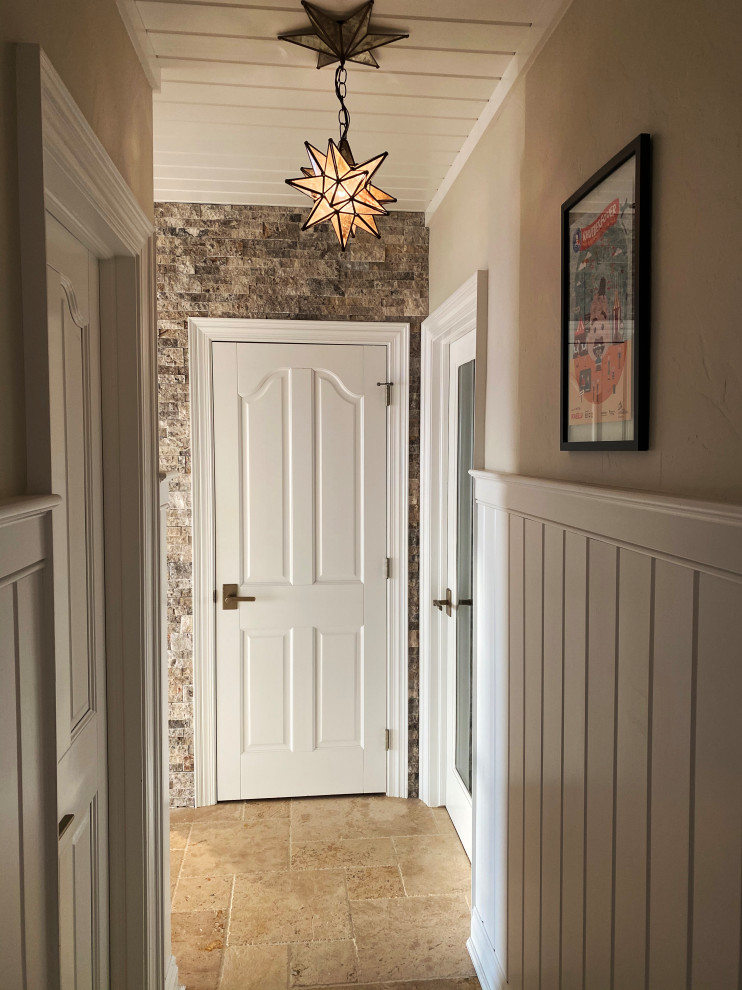 Example of a huge transitional marble floor, brown floor, wood ceiling and wall paneling hallway design in Milwaukee
