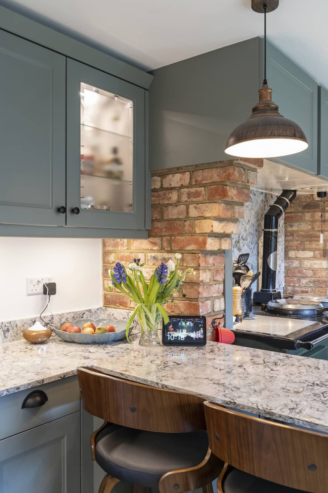 Inspiration for a large rural u-shaped enclosed kitchen in Buckinghamshire with shaker cabinets, black cabinets, quartz worktops, black appliances and terracotta flooring.