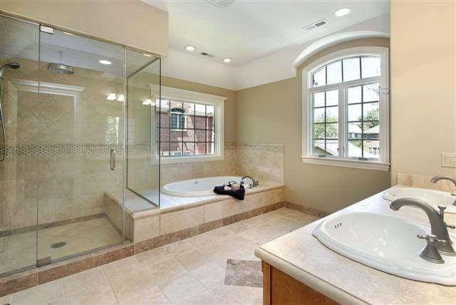 Inspiration for a large traditional master bathroom in Orange County with medium wood cabinets, a drop-in tub, an alcove shower, a two-piece toilet, beige tile, ceramic tile, beige walls, ceramic floors, a drop-in sink, laminate benchtops, beige floor and a hinged shower door.