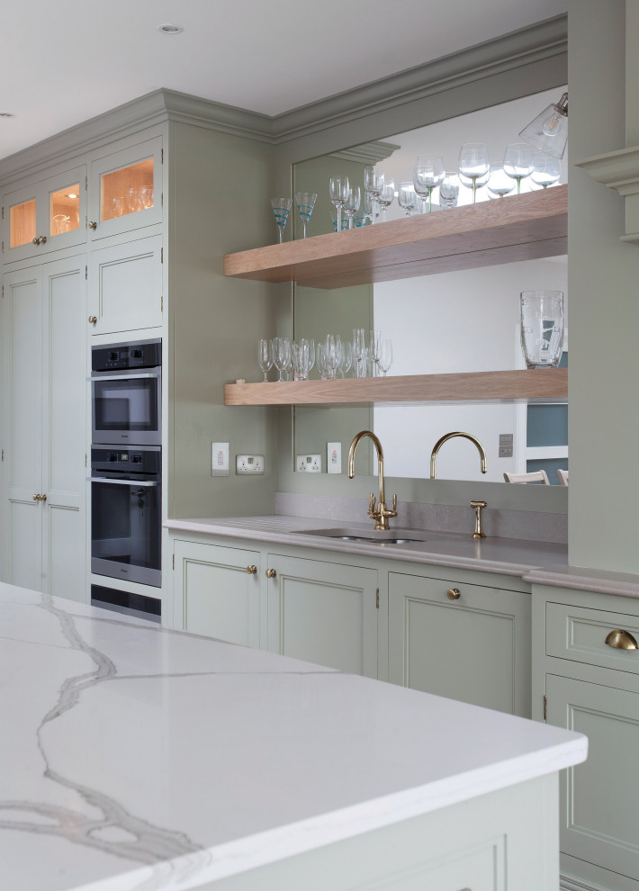 Eat-in kitchen - mid-sized french country single-wall eat-in kitchen idea in Other with recessed-panel cabinets, green cabinets, wood countertops, an island and white countertops
