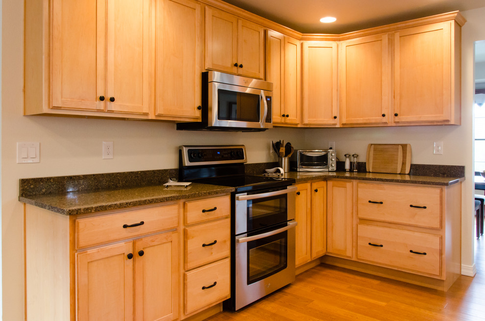Enclosed kitchen - mid-sized transitional u-shaped light wood floor and brown floor enclosed kitchen idea in Denver with a double-bowl sink, recessed-panel cabinets, light wood cabinets, granite countertops, stainless steel appliances and no island