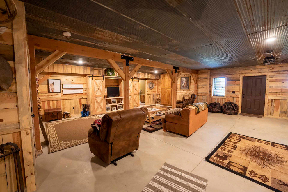 Basement - mid-sized rustic walk-out concrete floor, gray floor and shiplap wall basement idea with brown walls and no fireplace