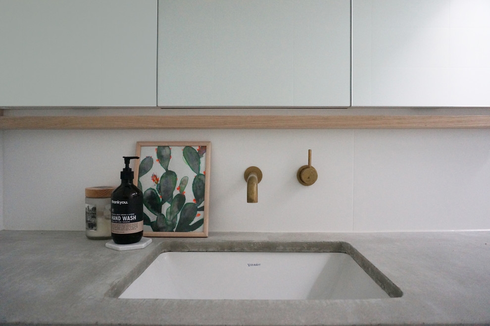 Photo of a contemporary master bathroom in Melbourne with white cabinets, white walls, an undermount sink and concrete benchtops.