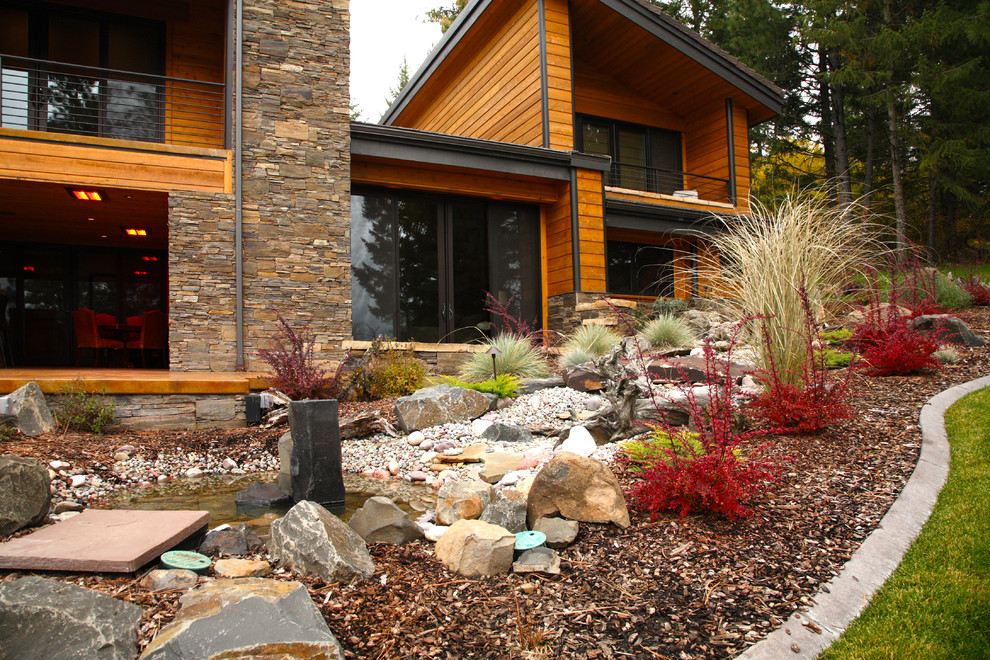 Photo of a large arts and crafts side yard driveway in Seattle with a water feature and natural stone pavers.